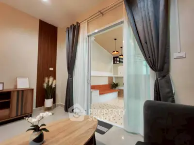 Modern living room with elegant decor and sliding glass doors leading to a stylish patio.