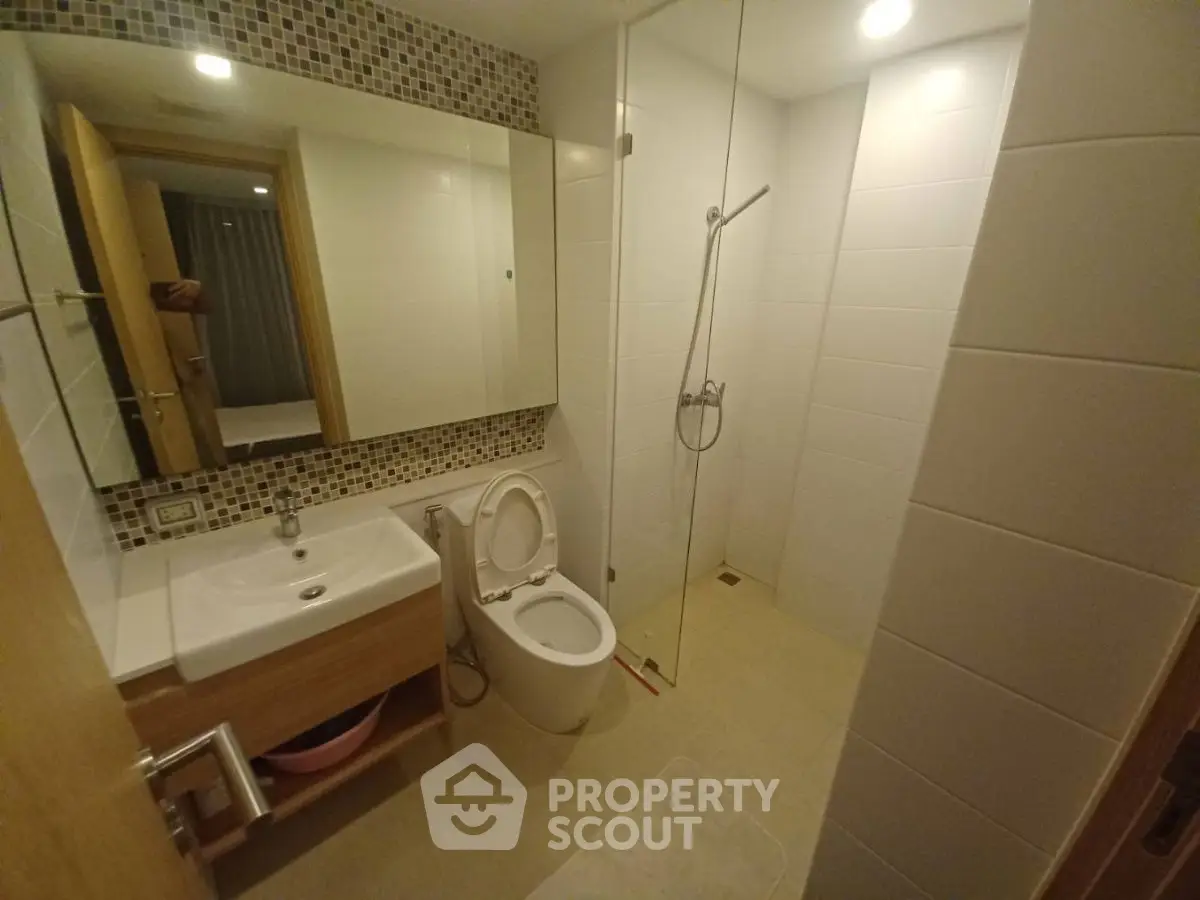 Modern bathroom with sleek fixtures and spacious shower area.
