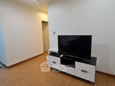 Modern living room with sleek TV stand and wooden flooring