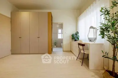 Spacious bedroom with elegant decor and natural light