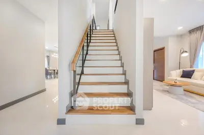 Modern interior with elegant staircase and cozy living area