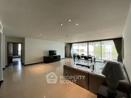 Spacious modern living room with large windows and elegant furnishings