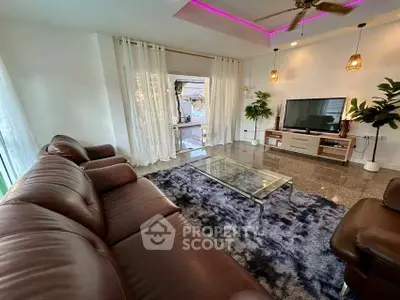 Spacious living room with modern decor and large leather sofa