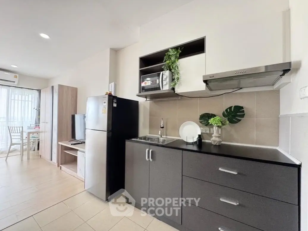 Modern kitchen with sleek cabinets and stainless steel appliances in a bright open layout.