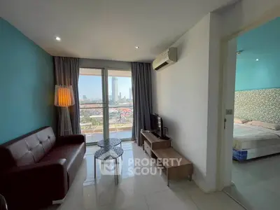 Modern living room with balcony view and adjacent bedroom in stylish apartment.