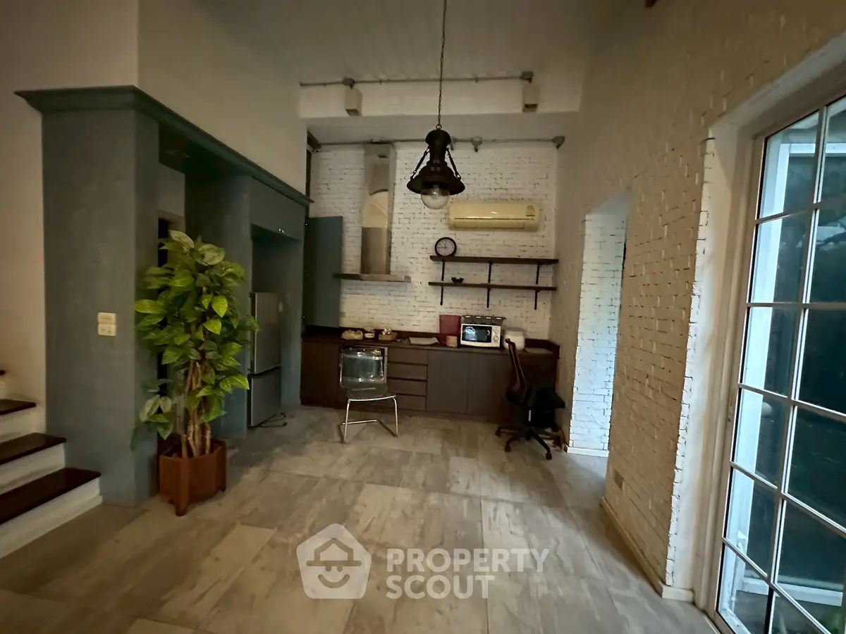 Charming industrial-style living space with exposed brick and modern kitchen amenities.