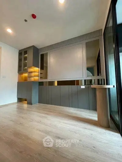 Modern interior with sleek cabinetry and wooden flooring, perfect for stylish living.