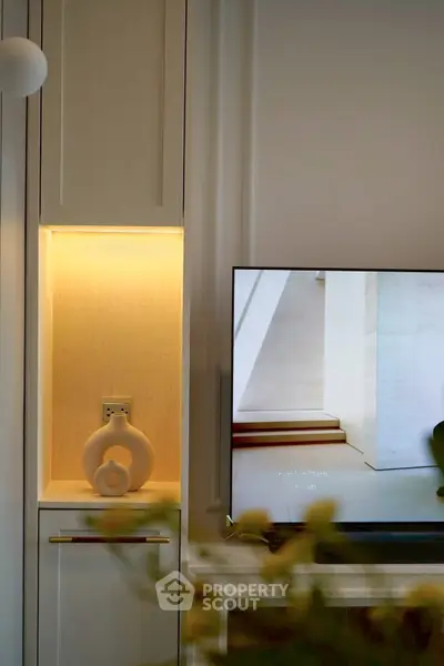 Modern living room with sleek TV setup and ambient lighting