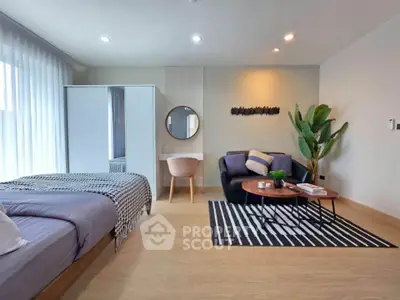 Modern studio apartment with cozy living area and stylish decor