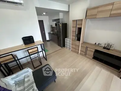 Modern open-layout living room with sleek kitchen and stylish furniture
