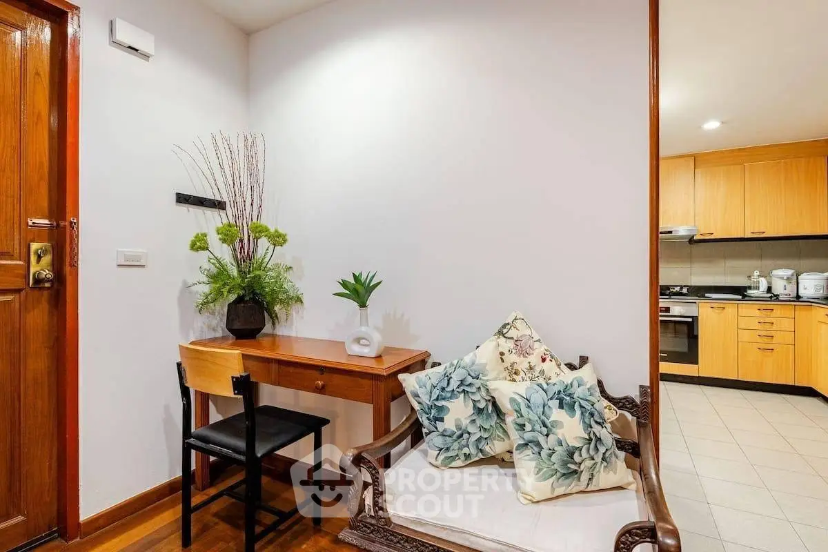 Charming interior with elegant seating and modern kitchen in cozy apartment.