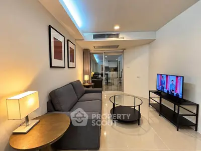Modern living room with sleek furniture and ambient lighting in a stylish apartment.