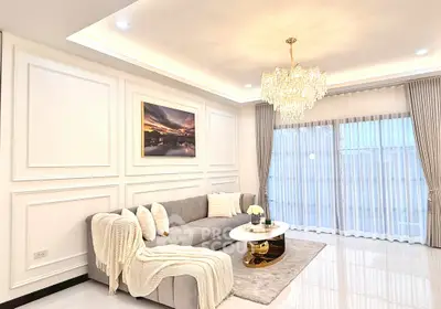 Elegant living room with chandelier, plush sofa, and large window drapes.
