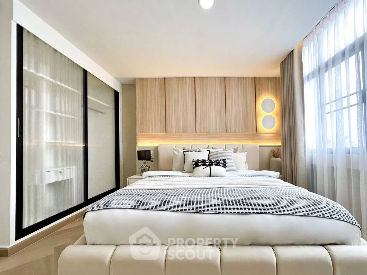 Luxurious modern bedroom with elegant decor and ample natural light