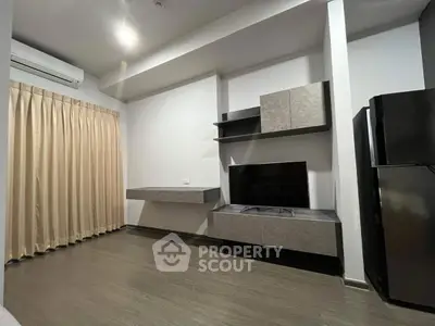 Modern living room with sleek TV unit and air conditioning, perfect for contemporary living.