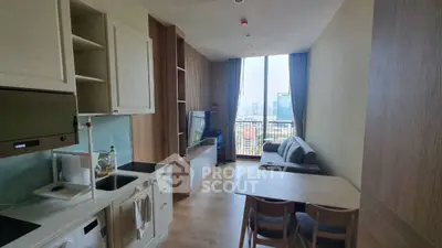 Modern open-plan living room with kitchen and city view, featuring sleek furniture and natural light.