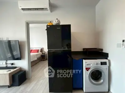 Modern apartment with sleek appliances and cozy bedroom view