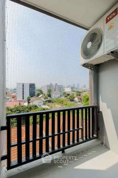 Charming balcony with city view and air conditioning unit, perfect for relaxation and enjoying urban scenery.
