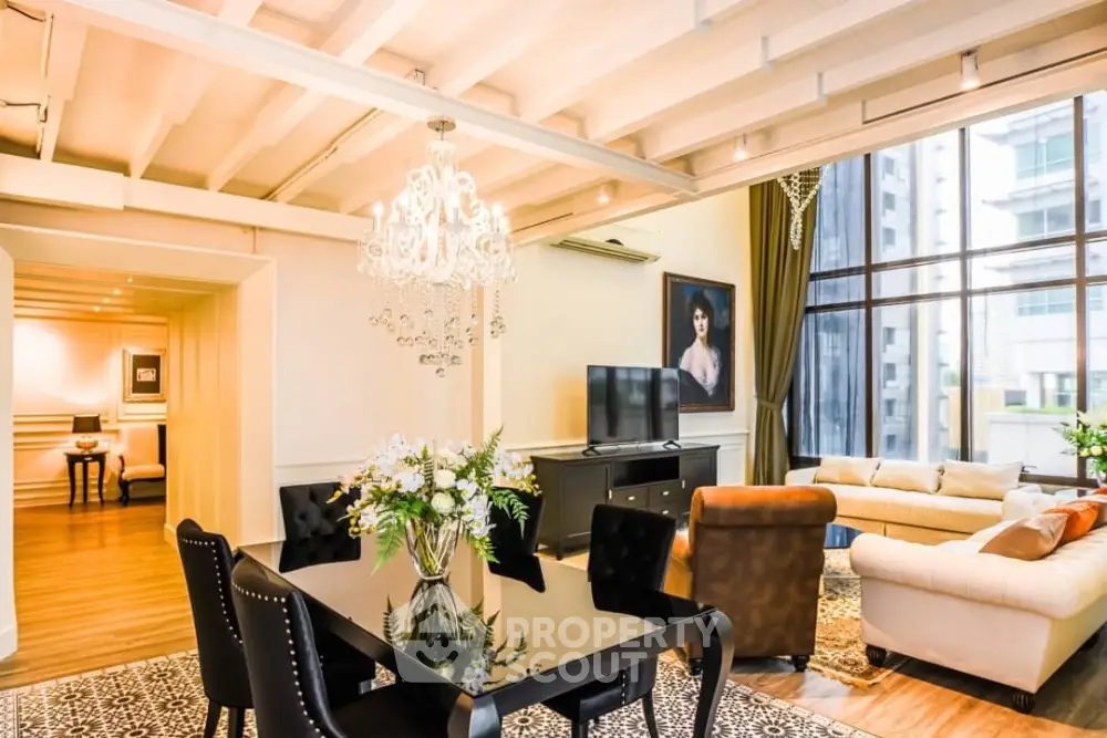 Luxurious living room with elegant chandelier and large windows in modern apartment