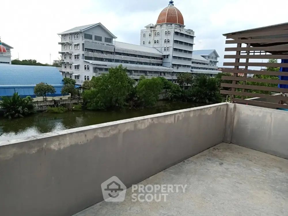 Spacious rooftop with scenic view of modern buildings and lush greenery