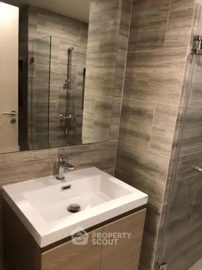 Modern bathroom with sleek sink and glass shower enclosure