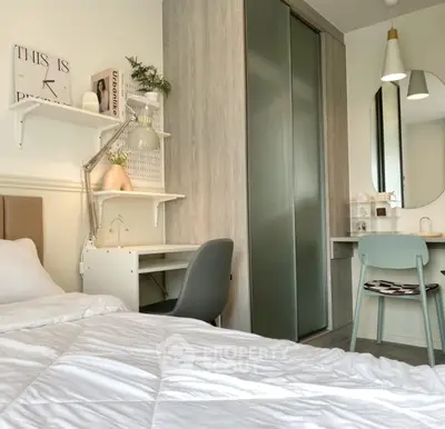 Modern bedroom with stylish decor and workspace, featuring a cozy bed and sleek furniture.