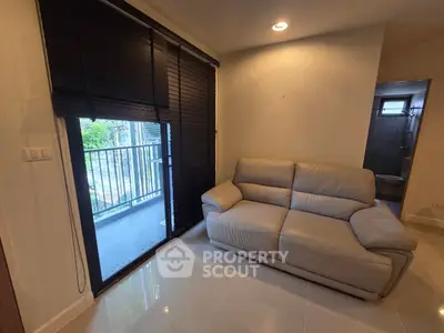 Cozy living room with modern sofa and balcony view