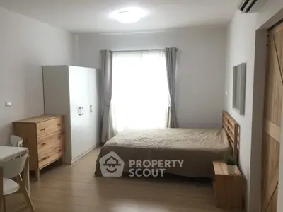 Cozy minimalist bedroom with natural light and modern furnishings