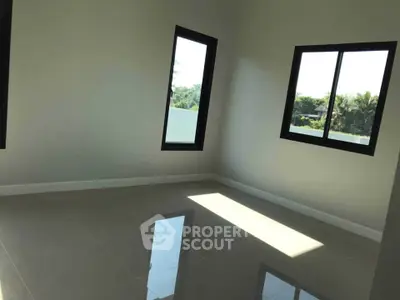 Bright empty room with large windows and glossy tiled floor