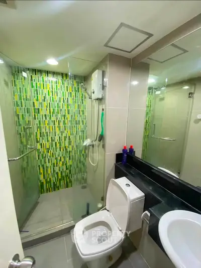 Modern bathroom with glass shower and vibrant mosaic tiles