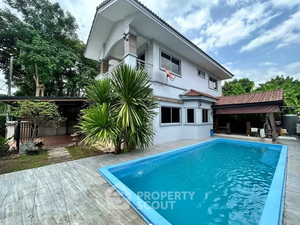Charming two-story house with private pool and lush garden, perfect for family living.