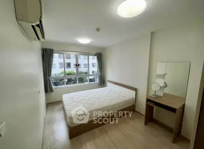 Spacious bedroom with natural light and modern furnishings in a prime real estate location.