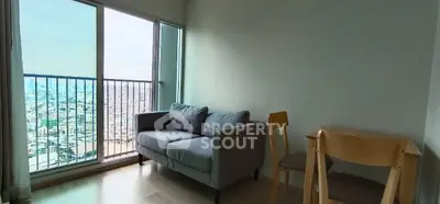 Modern living room with city view, featuring a cozy sofa and dining area.