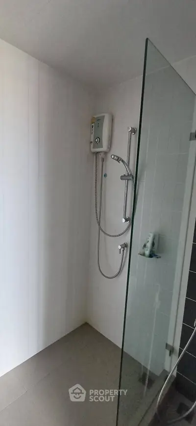 Modern bathroom with glass shower partition and electric water heater