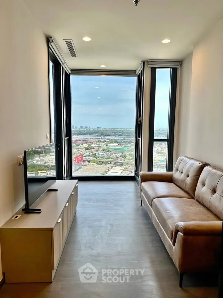 Modern living room with stunning city view and cozy leather sofa