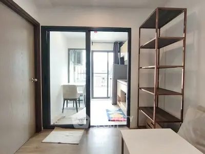 Modern apartment interior with open layout and stylish shelving unit.