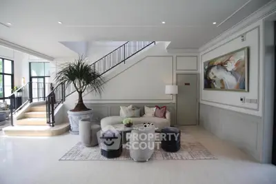 Luxurious living room with elegant staircase and modern decor