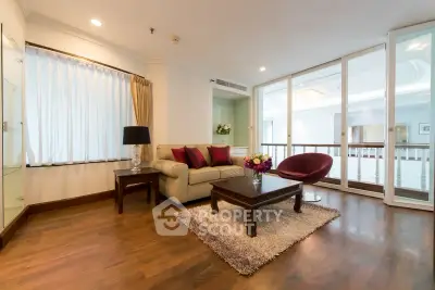 Spacious living room with elegant decor and large windows for natural light.