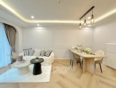 Elegant living room with modern dining area and stylish lighting