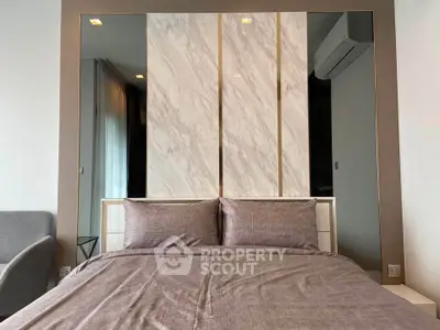 Modern bedroom with stylish decor and air conditioning unit, perfect for comfort and relaxation.