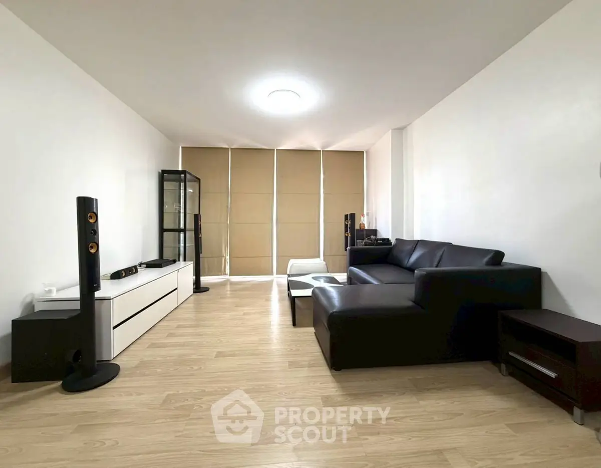 Modern living room with sleek black sofa and minimalist decor