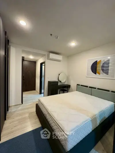 Modern bedroom with stylish decor and comfortable bed in a contemporary apartment.