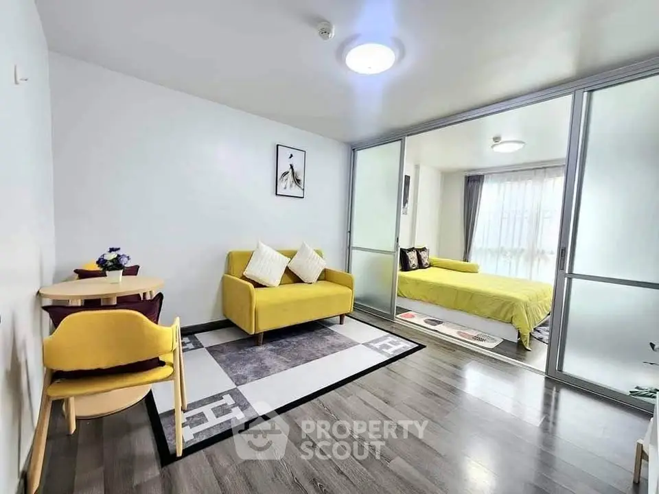 Modern living room with yellow sofa and bedroom view in stylish apartment