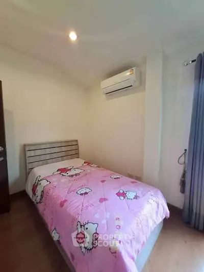 Cozy bedroom with air conditioning and charming decor, perfect for a comfortable living experience.