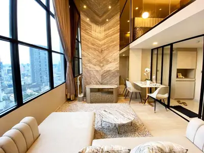 Luxurious modern living room with high ceilings and city view, featuring elegant decor and open layout.