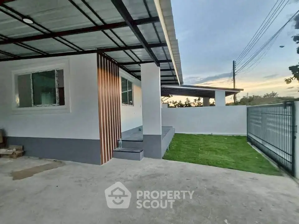 Modern single-story home with spacious driveway and lush green lawn