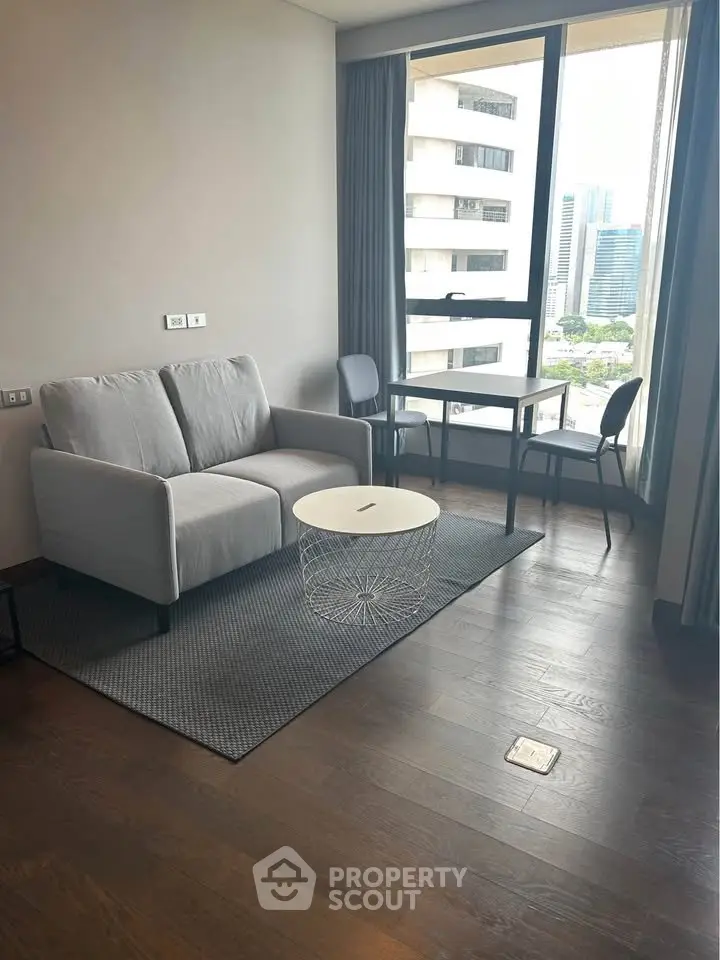 Modern living room with city view, featuring a cozy sofa and dining area, perfect for urban living.