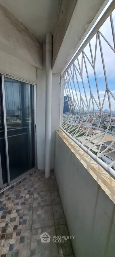 Spacious balcony with city view and secure railing in modern apartment