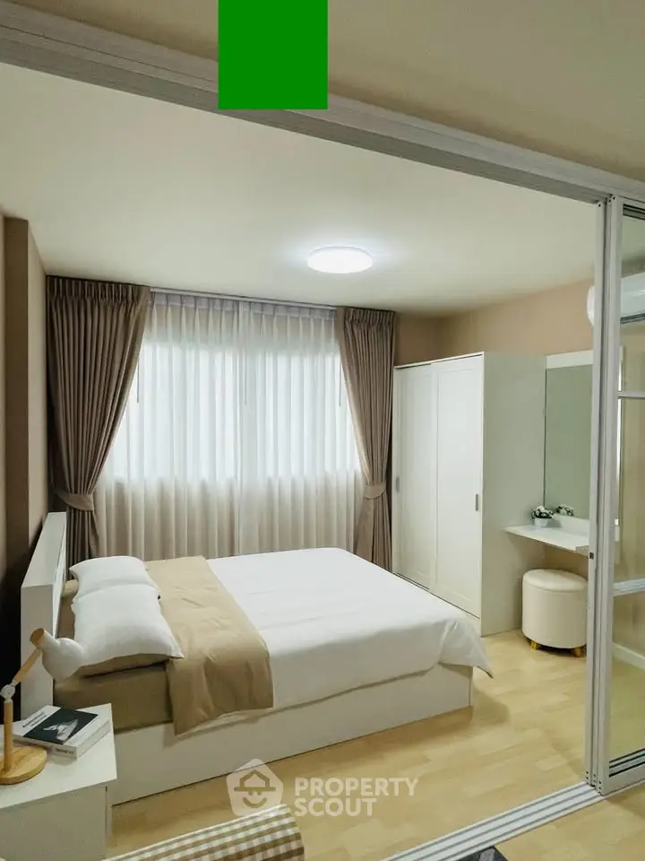 Modern bedroom with cozy decor and natural light, featuring a comfortable bed and stylish curtains.