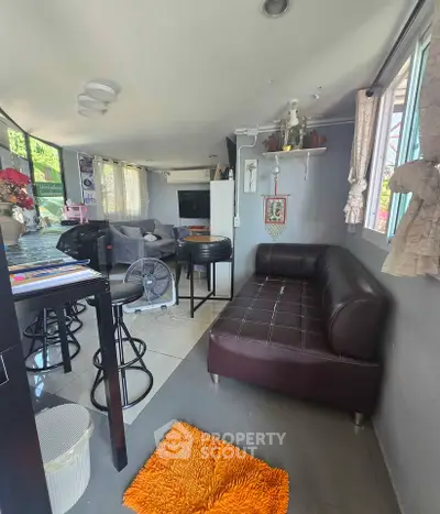 Stylish living room with modern furniture and large windows for natural light.